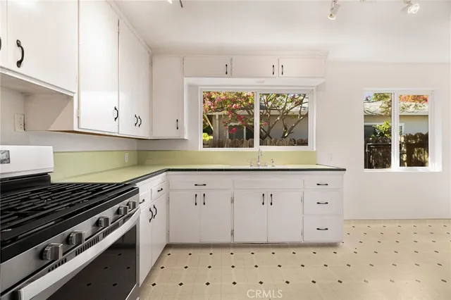 a kitchen with stainless steel appliances a refrigerator and a sink