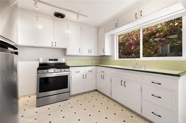 a view of a hallway with wooden floor and bathroom