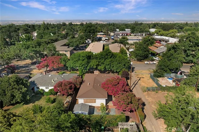 an aerial view of residential houses with city view