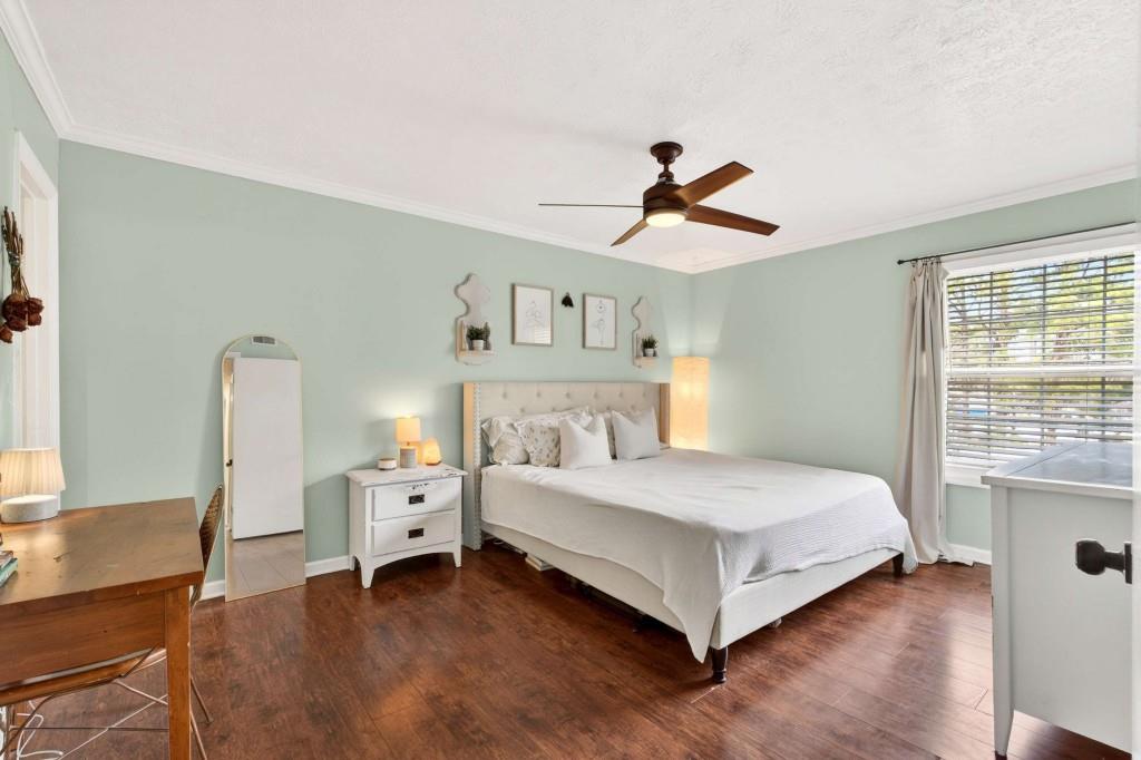725 Dalrymple Road, Unit 5F Sandy Springs, GA 30328 - Photo 20 of 33 a bedroom with a large bed and a chandelier
