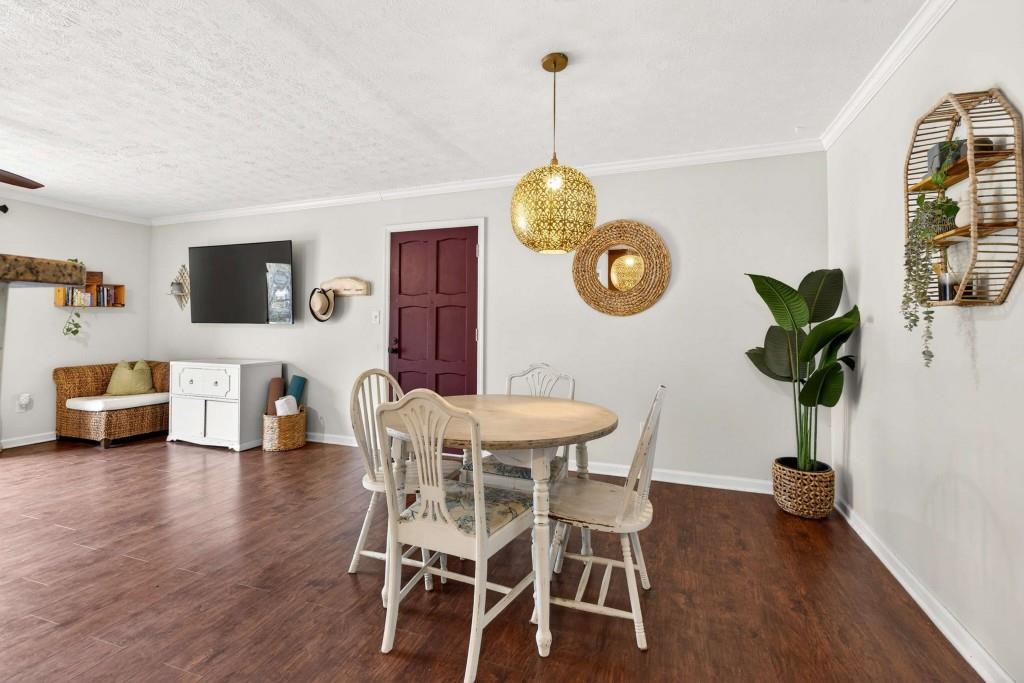 725 Dalrymple Road, Unit 5F Sandy Springs, GA 30328 - Photo 10 of 33 a view of a dining room with furniture wooden floor and chandelier