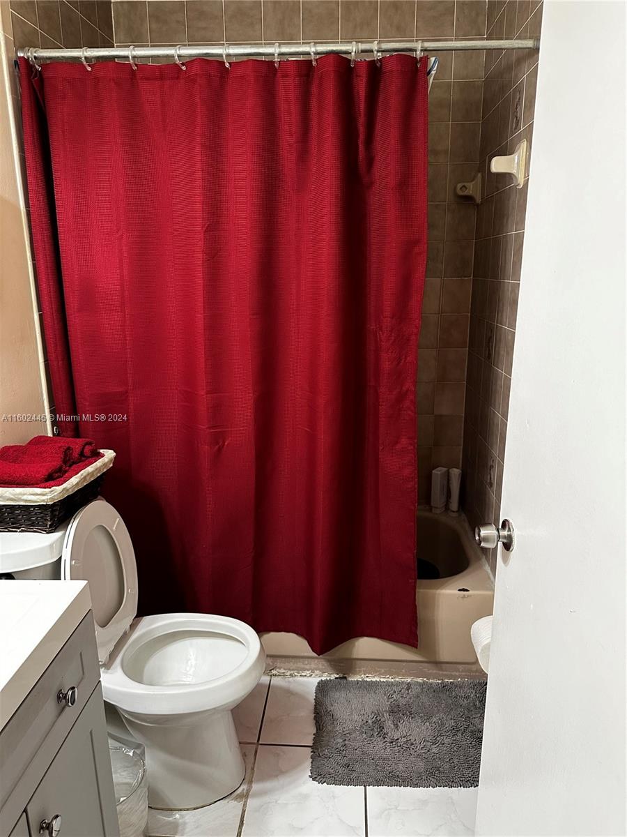 Westview Miami, FL 33167 - Photo 7 of 10 a bathroom with a toilet a sink and curtain