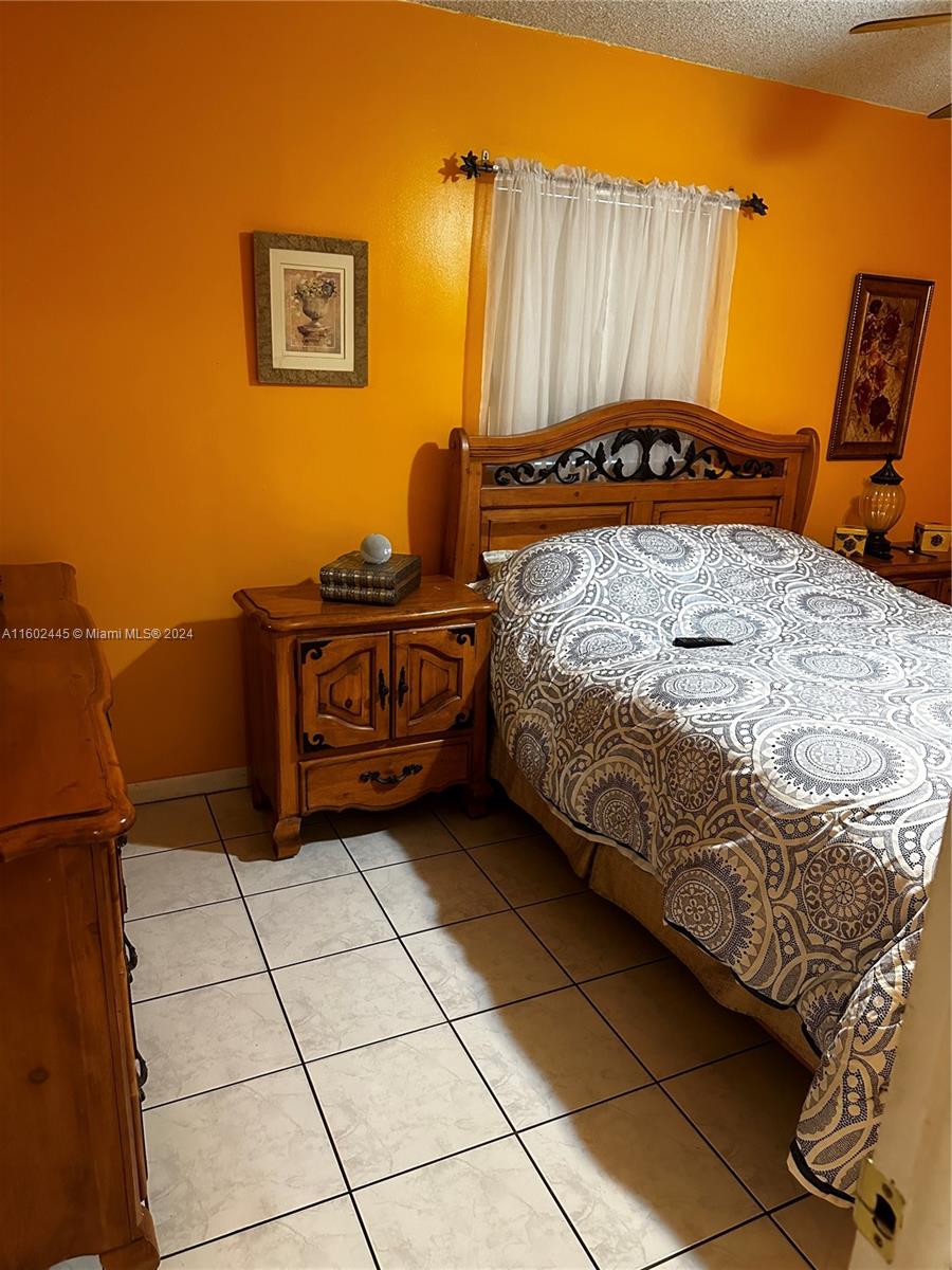 Westview Miami, FL 33167 - Photo 8 of 10 a bedroom with a bed and a window