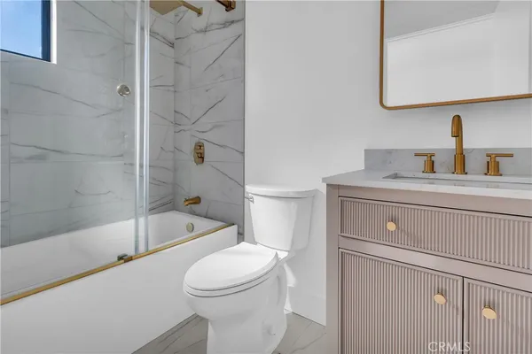 a white toilet sitting next to a bathroom sink