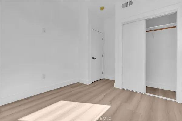 a bathroom with a sink a toilet a mirror and shower