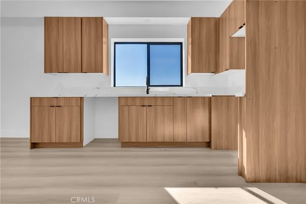 a view of a kitchen with wooden floor