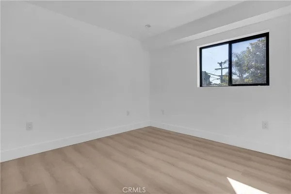 an empty room with wooden floor