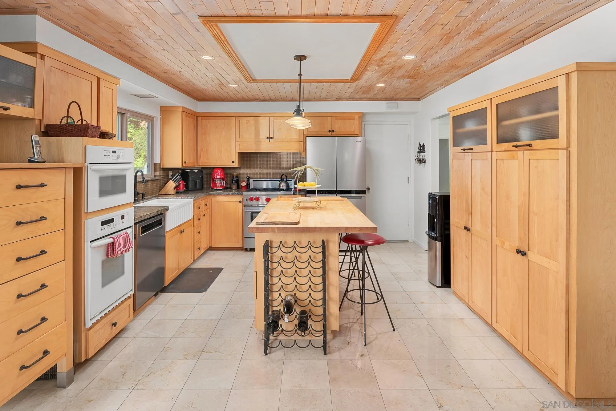 1669 Los Altos Road San Diego, CA 92109 - Photo 12 of 62 a kitchen with stainless steel appliances kitchen island granite countertop a refrigerator and a stove top oven