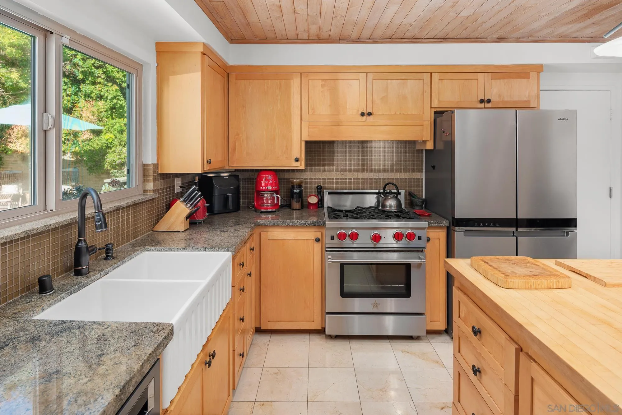 1669 Los Altos Road San Diego, CA 92109 - Photo 14 of 62 a kitchen with a stove a sink and a refrigerator