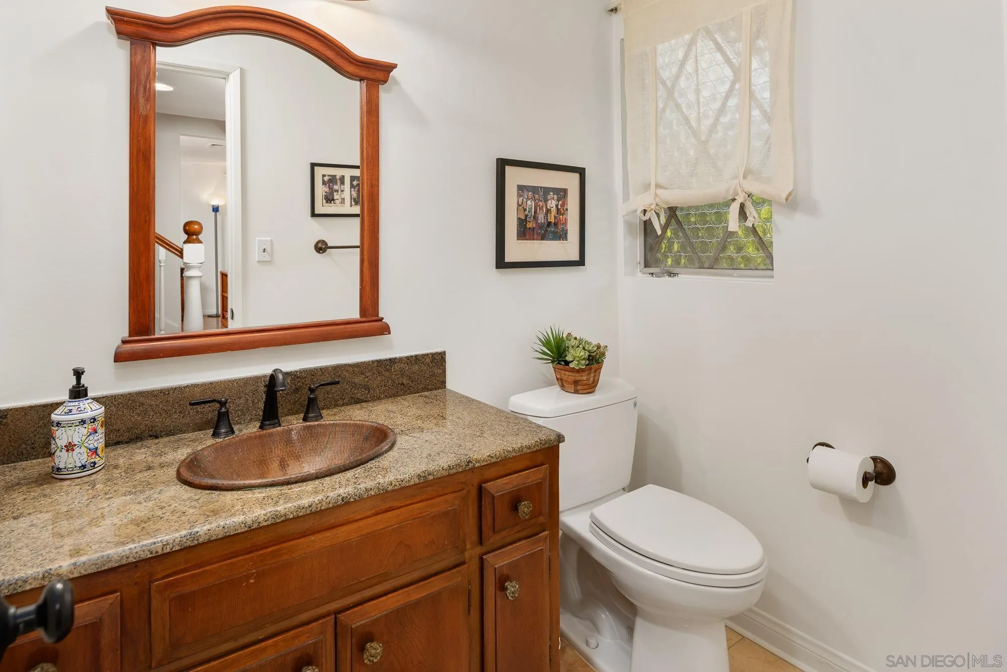 1669 Los Altos Road San Diego, CA 92109 - Photo 18 of 62 a bathroom with a granite countertop toilet sink and mirror