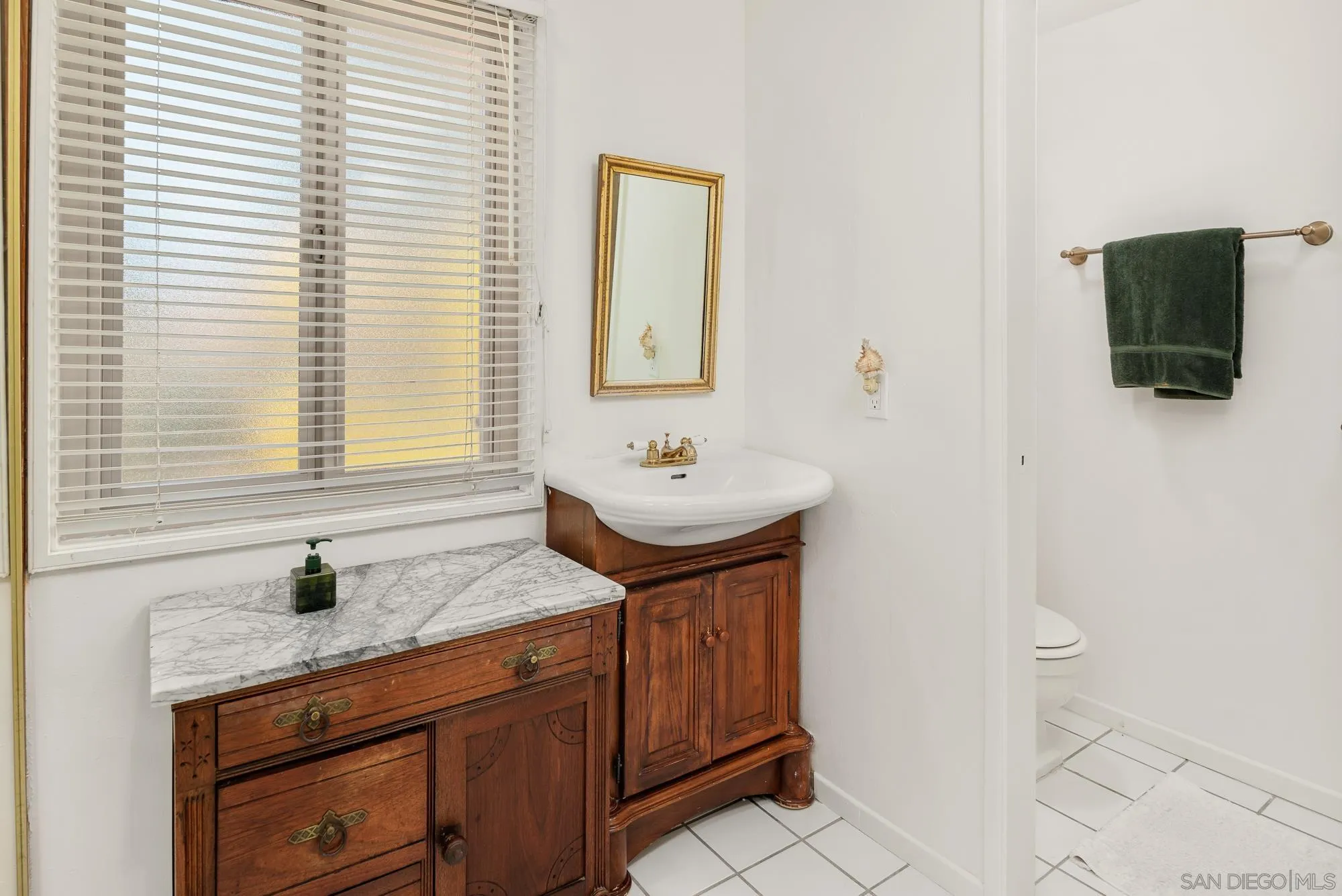 1669 Los Altos Road San Diego, CA 92109 - Photo 23 of 62 a bathroom with a sink a vanity and a mirror