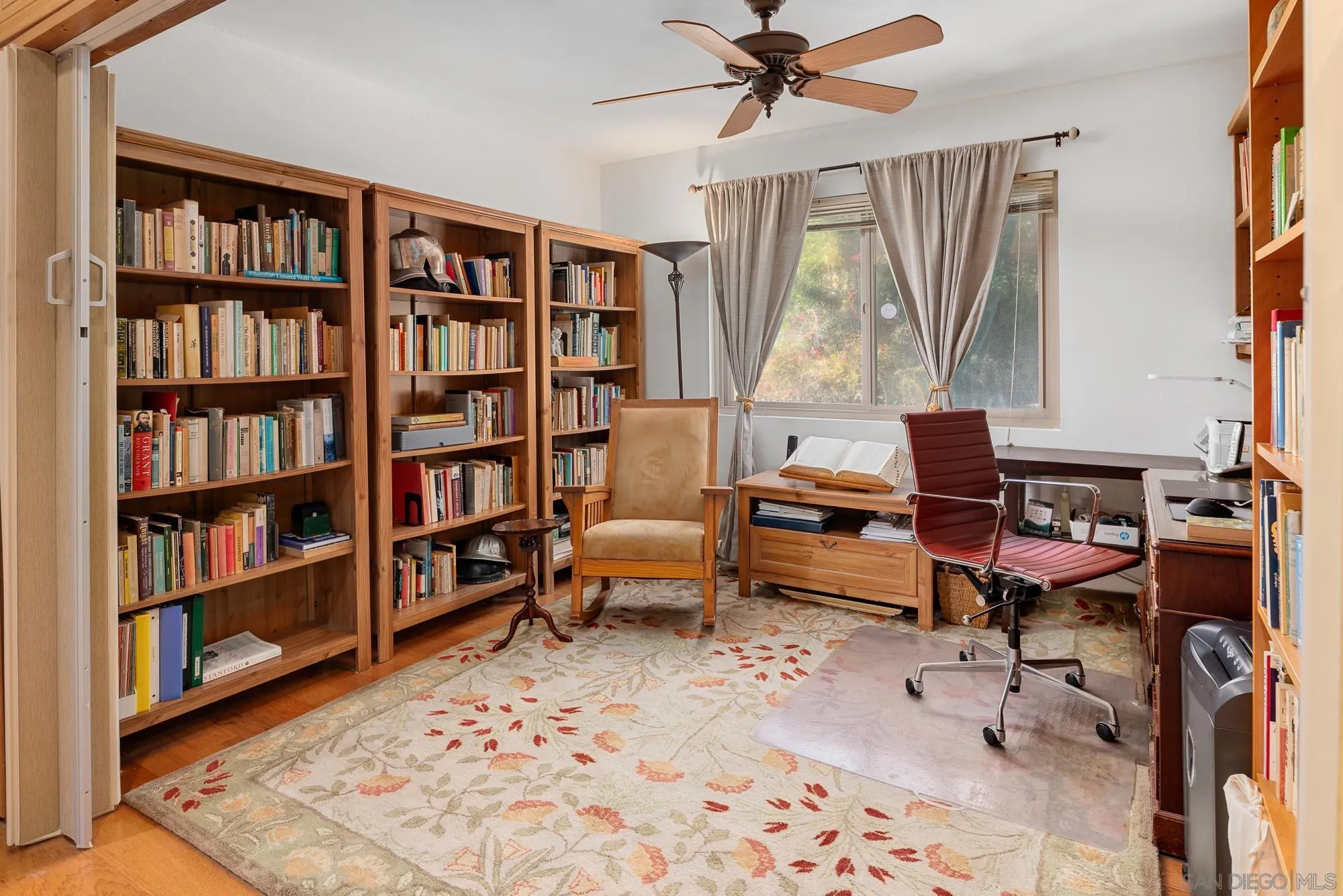 1669 Los Altos Road San Diego, CA 92109 - Photo 25 of 62 a living room with furniture and a book shelf