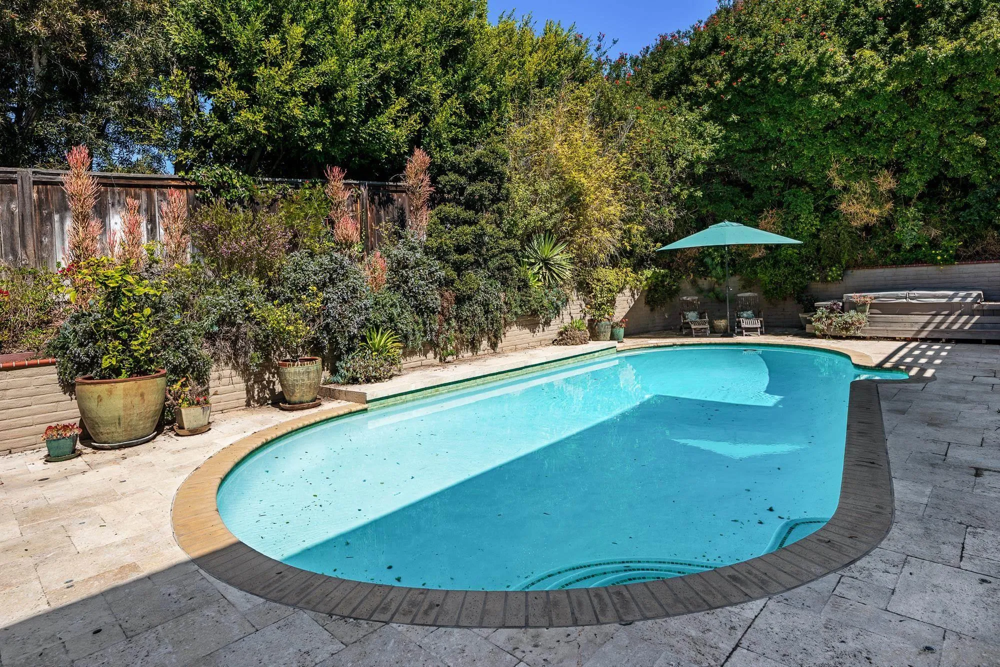 1669 Los Altos Road San Diego, CA 92109 - Photo 36 of 62 a view of a swimming pool with a patio and plants