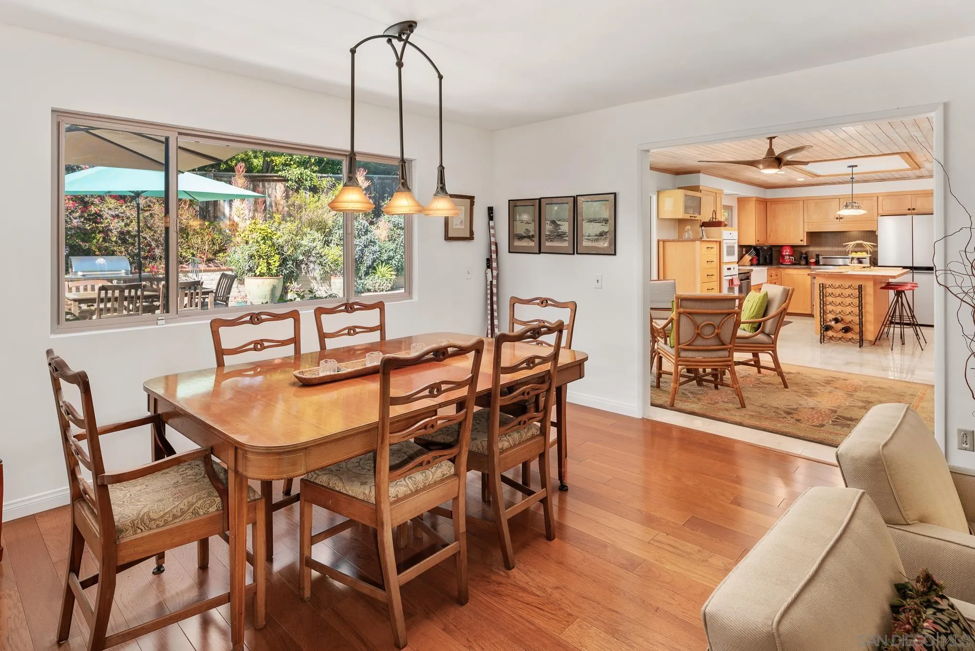 1669 Los Altos Road San Diego, CA 92109 - Photo 7 of 62 a dining room with furniture large windows and wooden floor