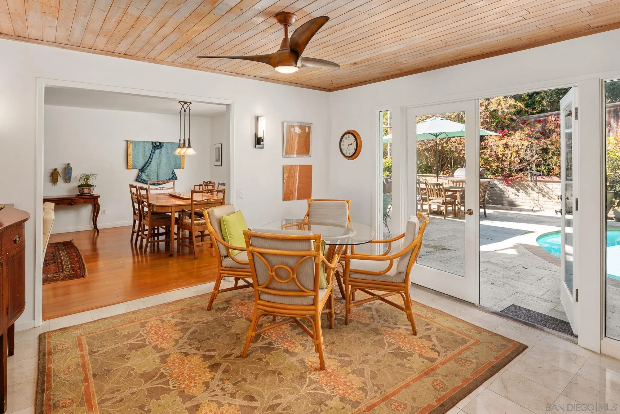 1669 Los Altos Road San Diego, CA 92109 - Photo 9 of 62 a dining room with furniture wooden floor a rug and a painting