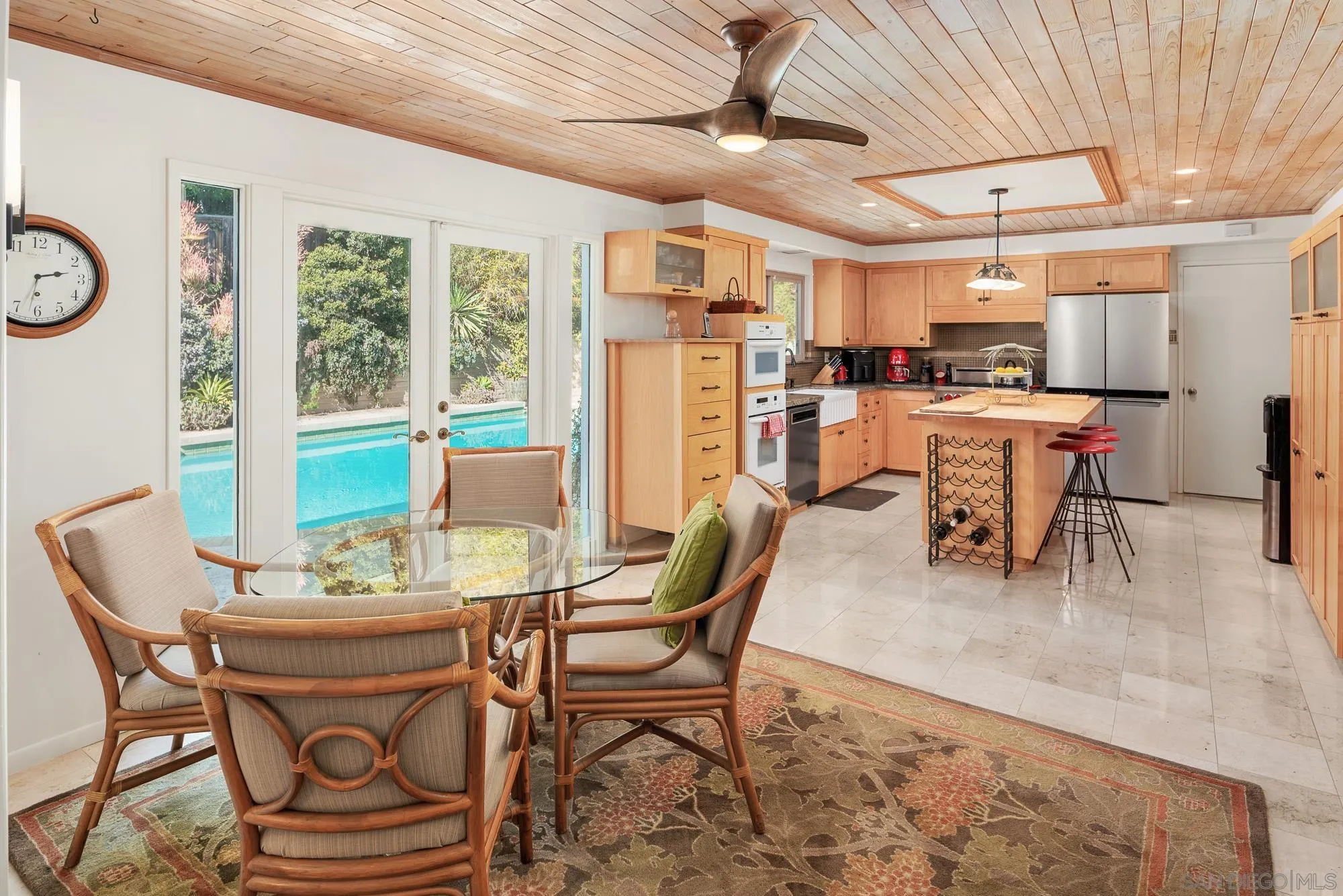 1669 Los Altos Road San Diego, CA 92109 - Photo 10 of 62 a dining room with furniture a floor to ceiling window and a clock