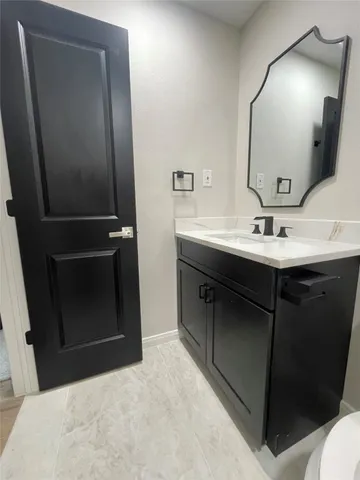 a bathroom with a sink and mirror
