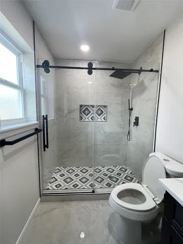 a bathroom with a sink toilet and shower