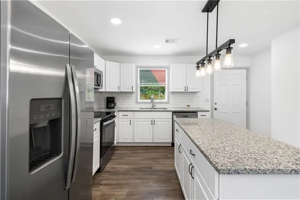 a kitchen with a sink stove and refrigerator