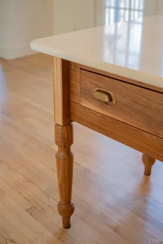 a kitchen with stainless steel appliances cabinets and a large window