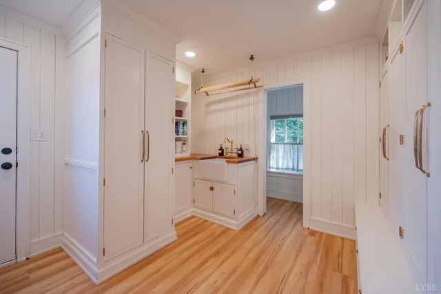 a kitchen with a sink and white cabinets
