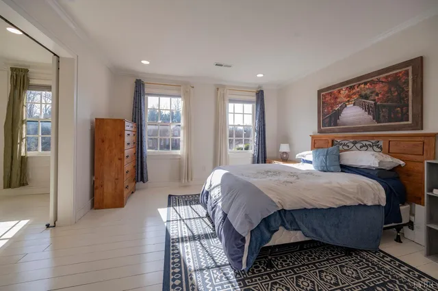 a dining hall with stainless steel appliances granite countertop a stove and a wooden floors