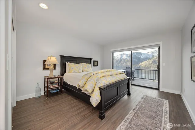 a large bed sitting in a bedroom next to a window