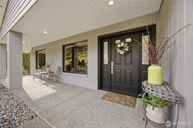 a living room with a couch and chairs