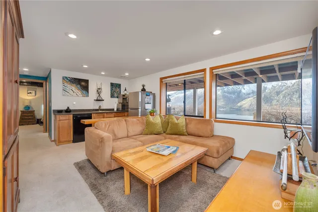 a view of a patio with table and chairs under an umbrella