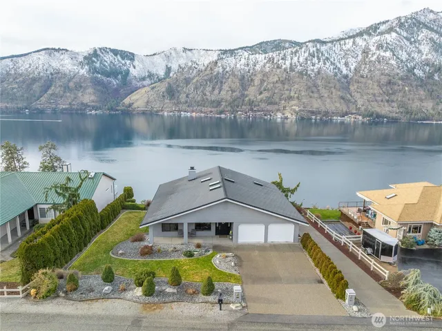 an aerial view of a house with a lake view
