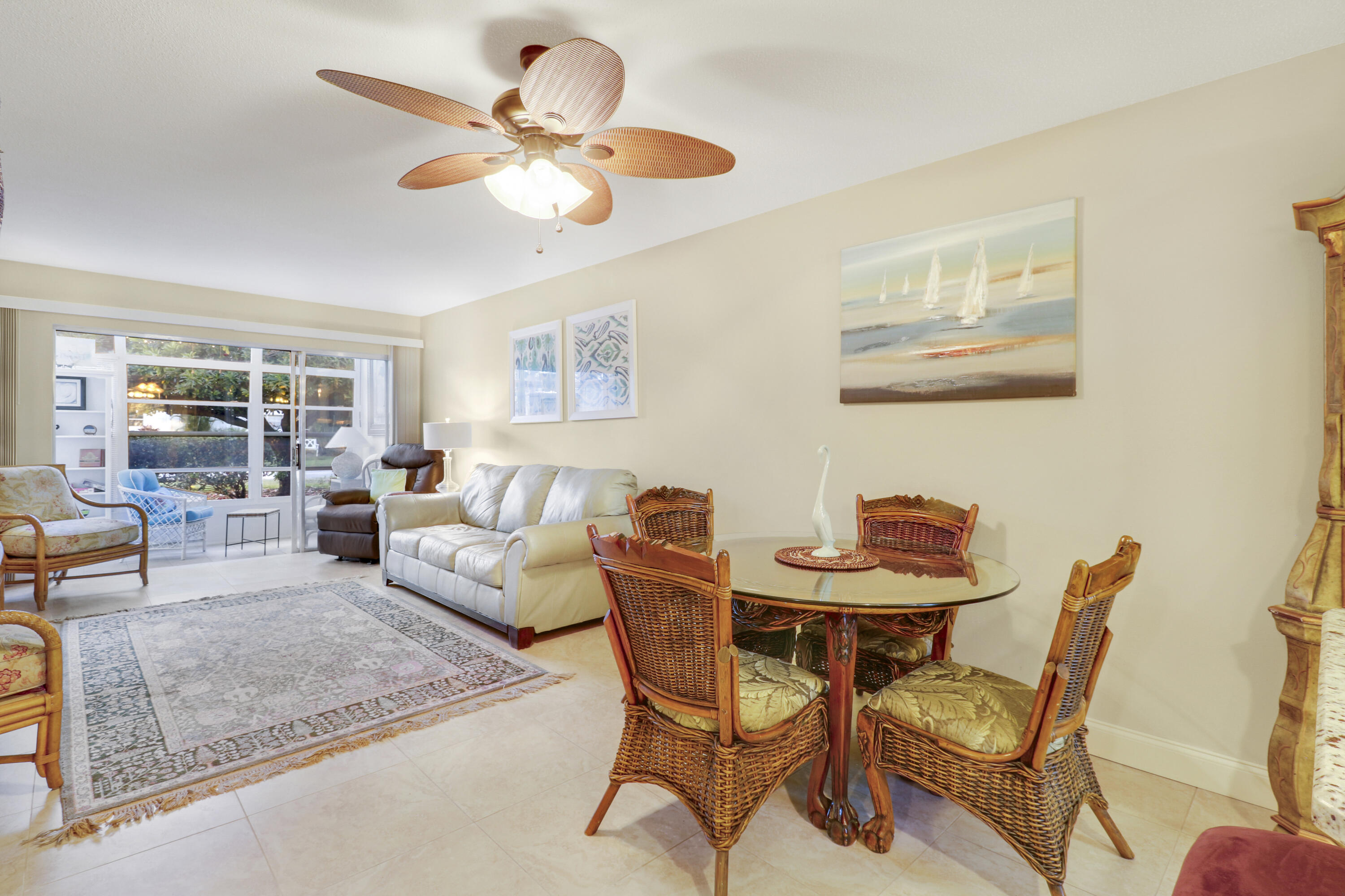 2929 Southeast Ocean Boulevard, Unit 1122 Stuart, FL 34996 - Photo 14 of 37 a living room with furniture and a chandelier