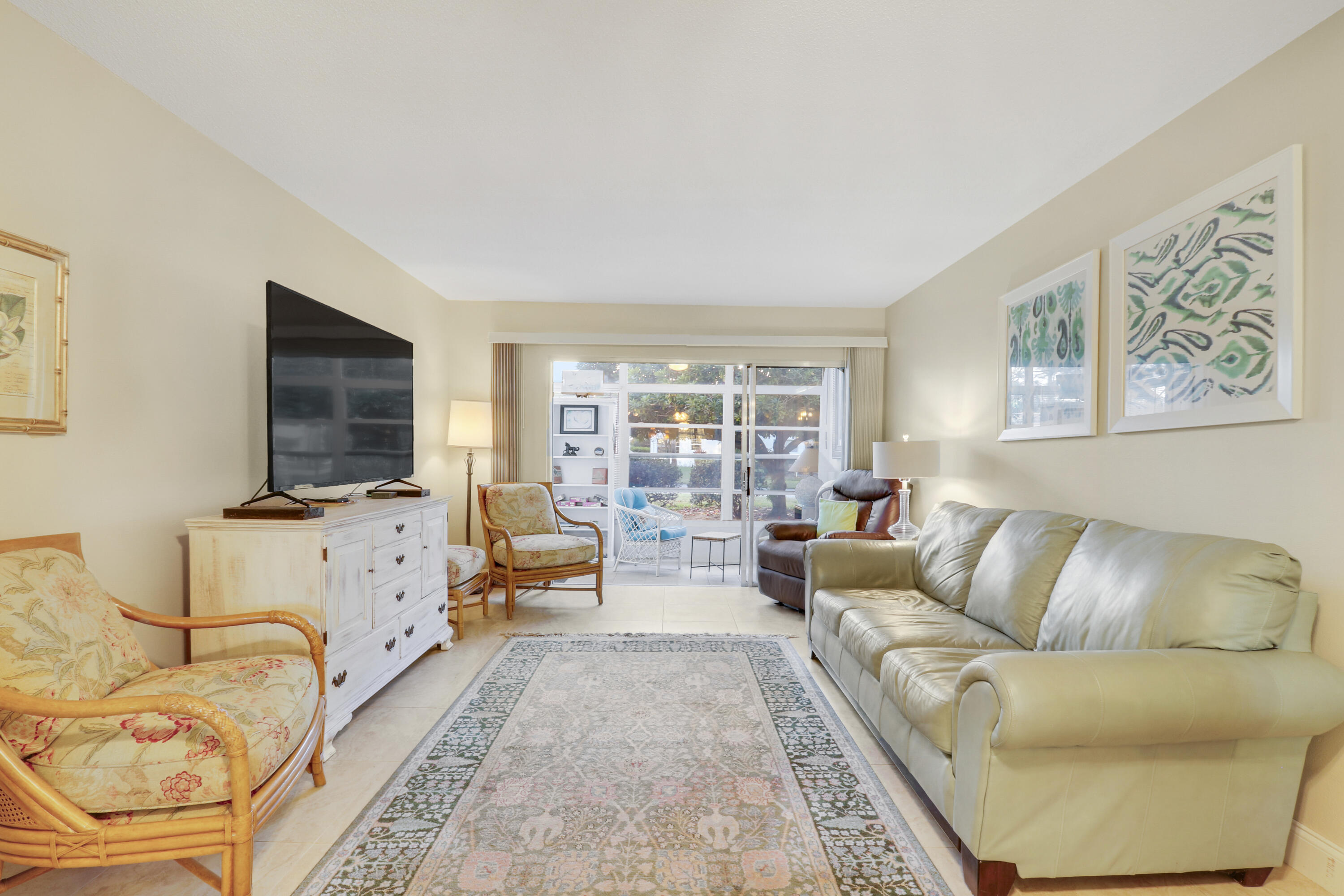 2929 Southeast Ocean Boulevard, Unit 1122 Stuart, FL 34996 - Photo 16 of 37 a living room with furniture and a flat screen tv