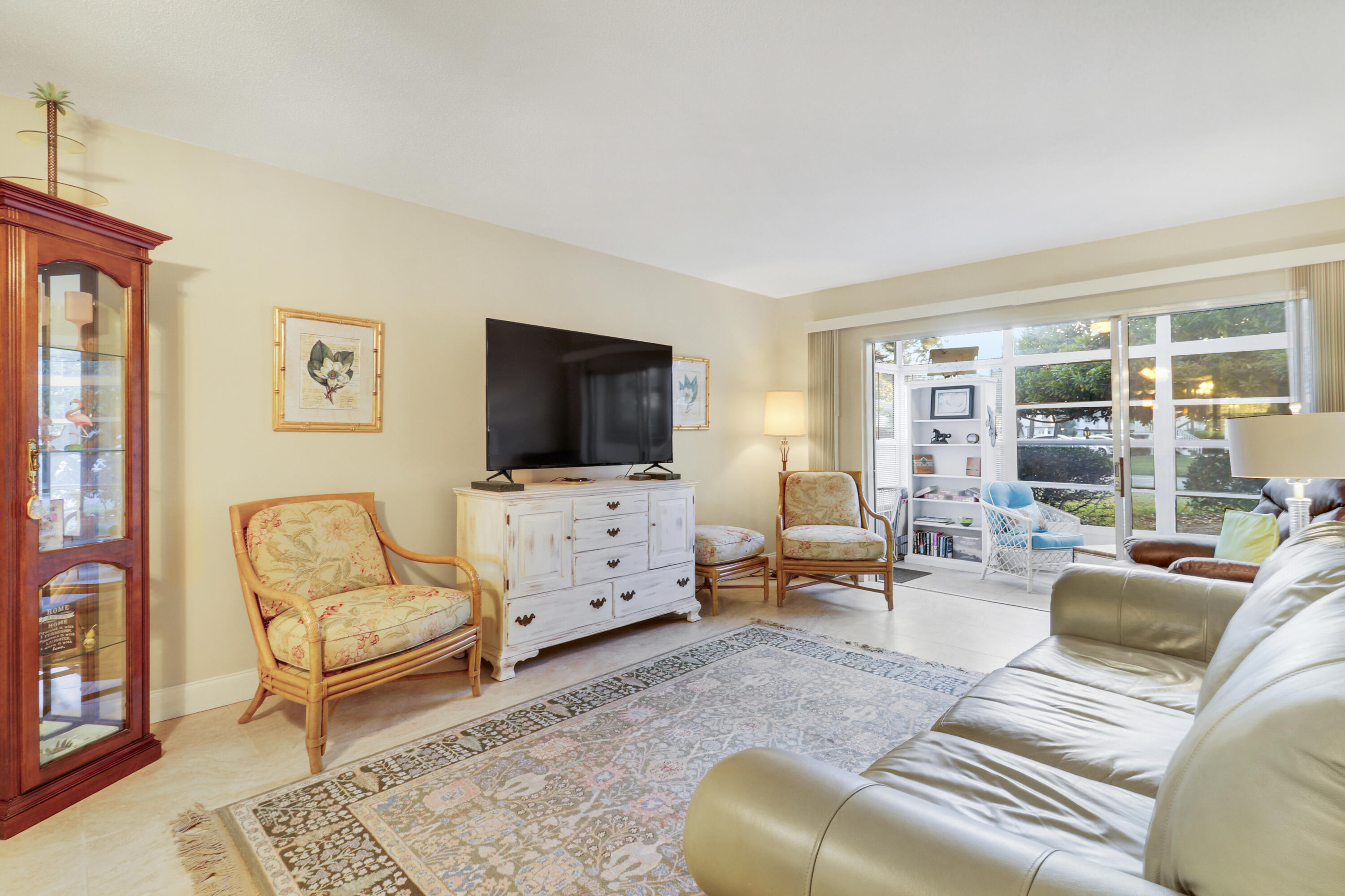 2929 Southeast Ocean Boulevard, Unit 1122 Stuart, FL 34996 - Photo 17 of 37 a living room with furniture and a flat screen tv