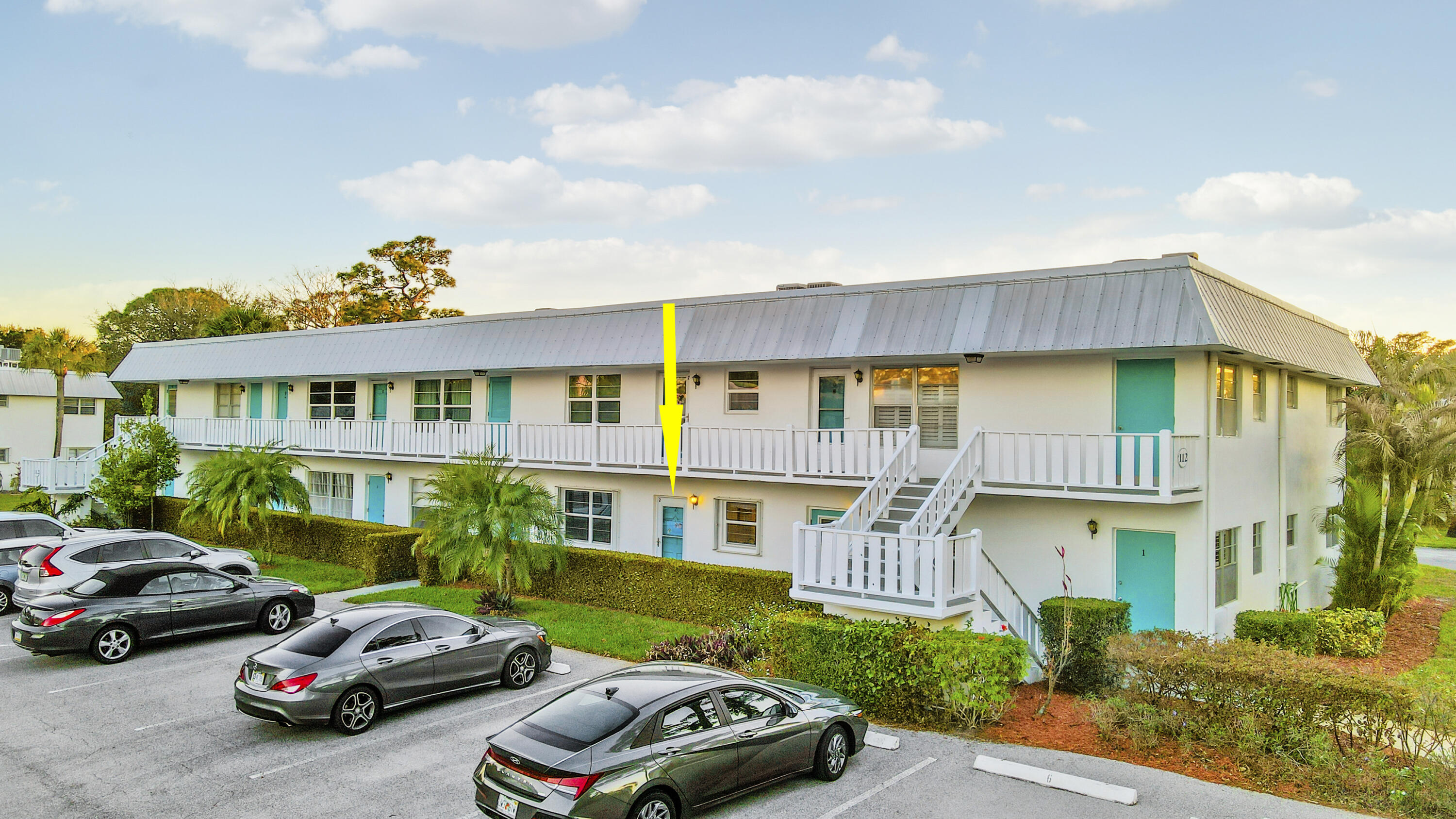 2929 Southeast Ocean Boulevard, Unit 1122 Stuart, FL 34996 - Photo 2 of 37 a front view of a residential apartment building with a yard
