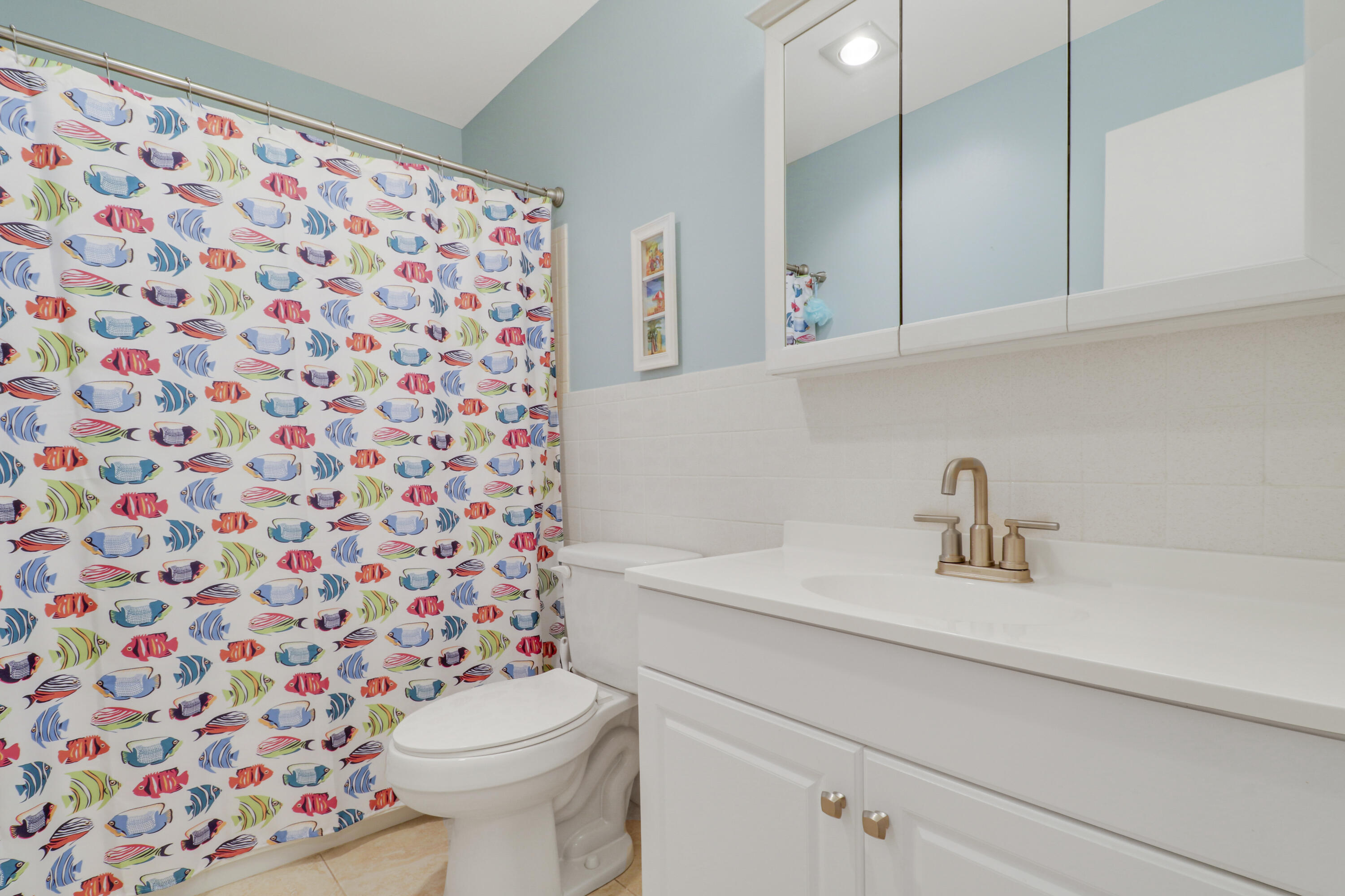 2929 Southeast Ocean Boulevard, Unit 1122 Stuart, FL 34996 - Photo 23 of 37 a bathroom with a sink and a toilet