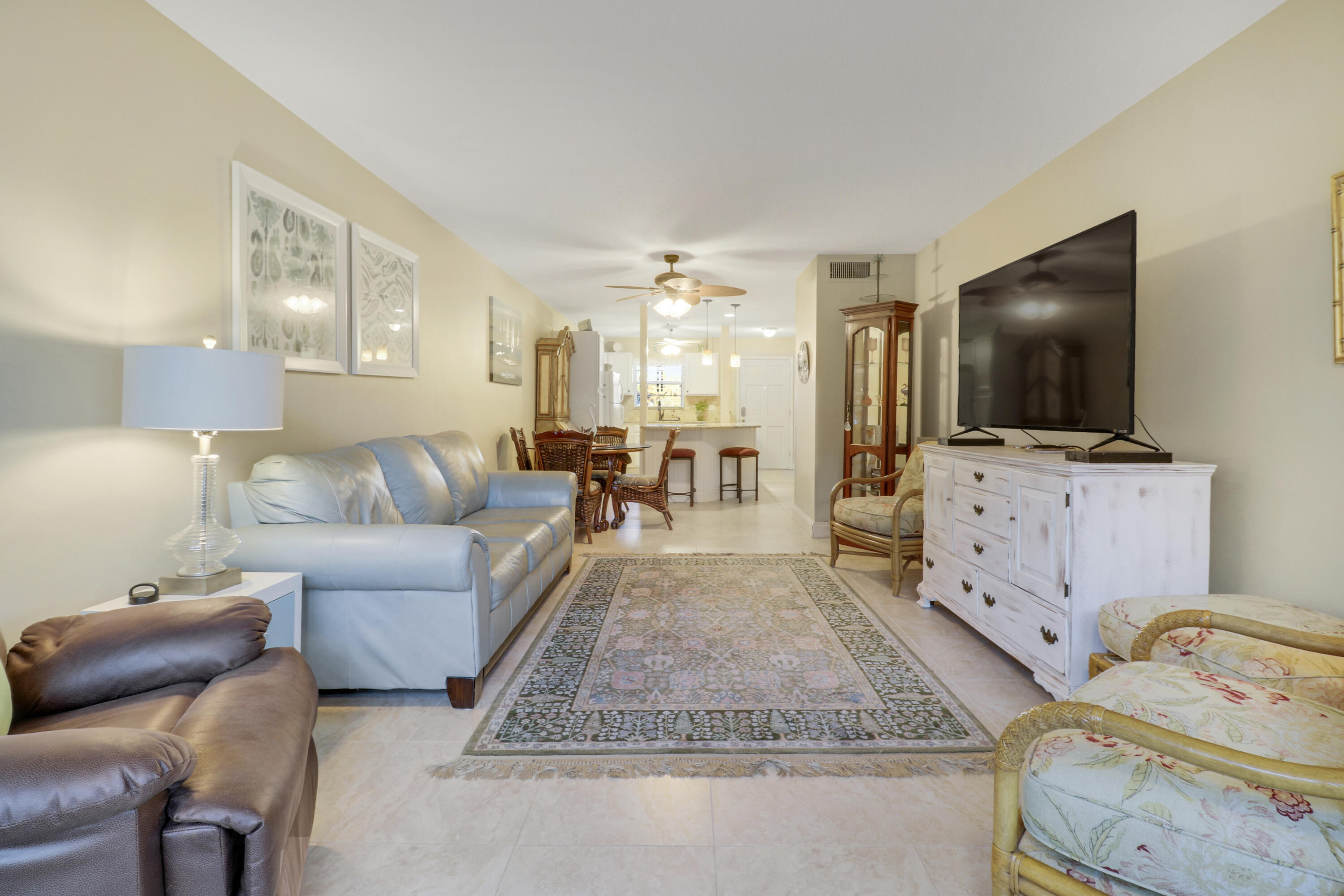 2929 Southeast Ocean Boulevard, Unit 1122 Stuart, FL 34996 - Photo 4 of 37 a living room with furniture and a flat screen tv