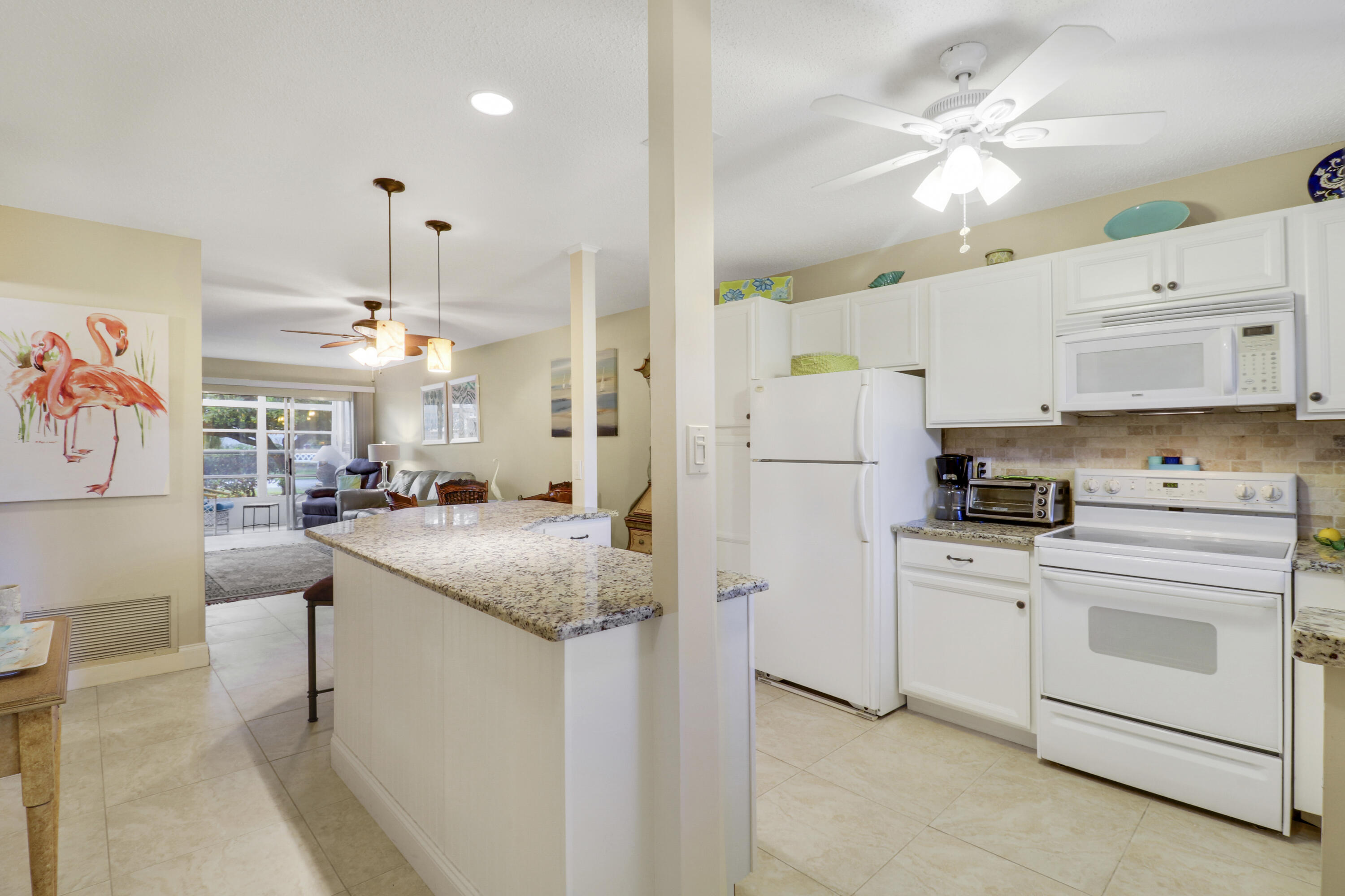 2929 Southeast Ocean Boulevard, Unit 1122 Stuart, FL 34996 - Photo 6 of 37 a kitchen with stainless steel appliances granite countertop a sink a stove and a refrigerator
