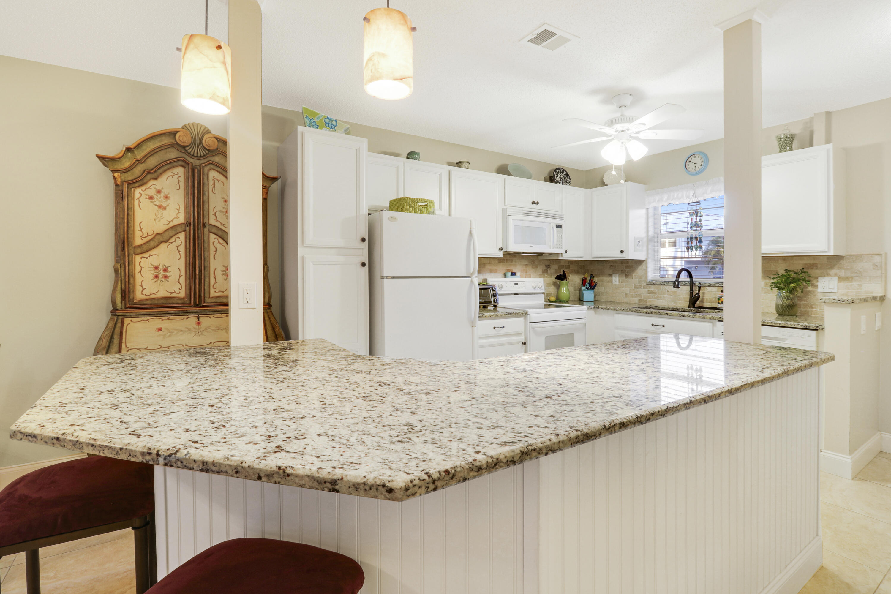 2929 Southeast Ocean Boulevard, Unit 1122 Stuart, FL 34996 - Photo 7 of 37 a kitchen with stainless steel appliances granite countertop a sink refrigerator and cabinets