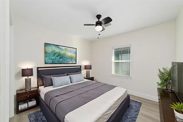 a bedroom with a large bed and a window