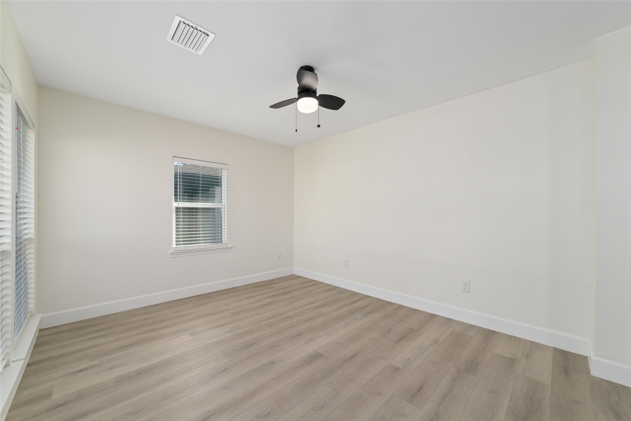 714 East 43rd Street Houston, TX 77022 - Photo 16 of 20 wooden floor in an empty room with a window