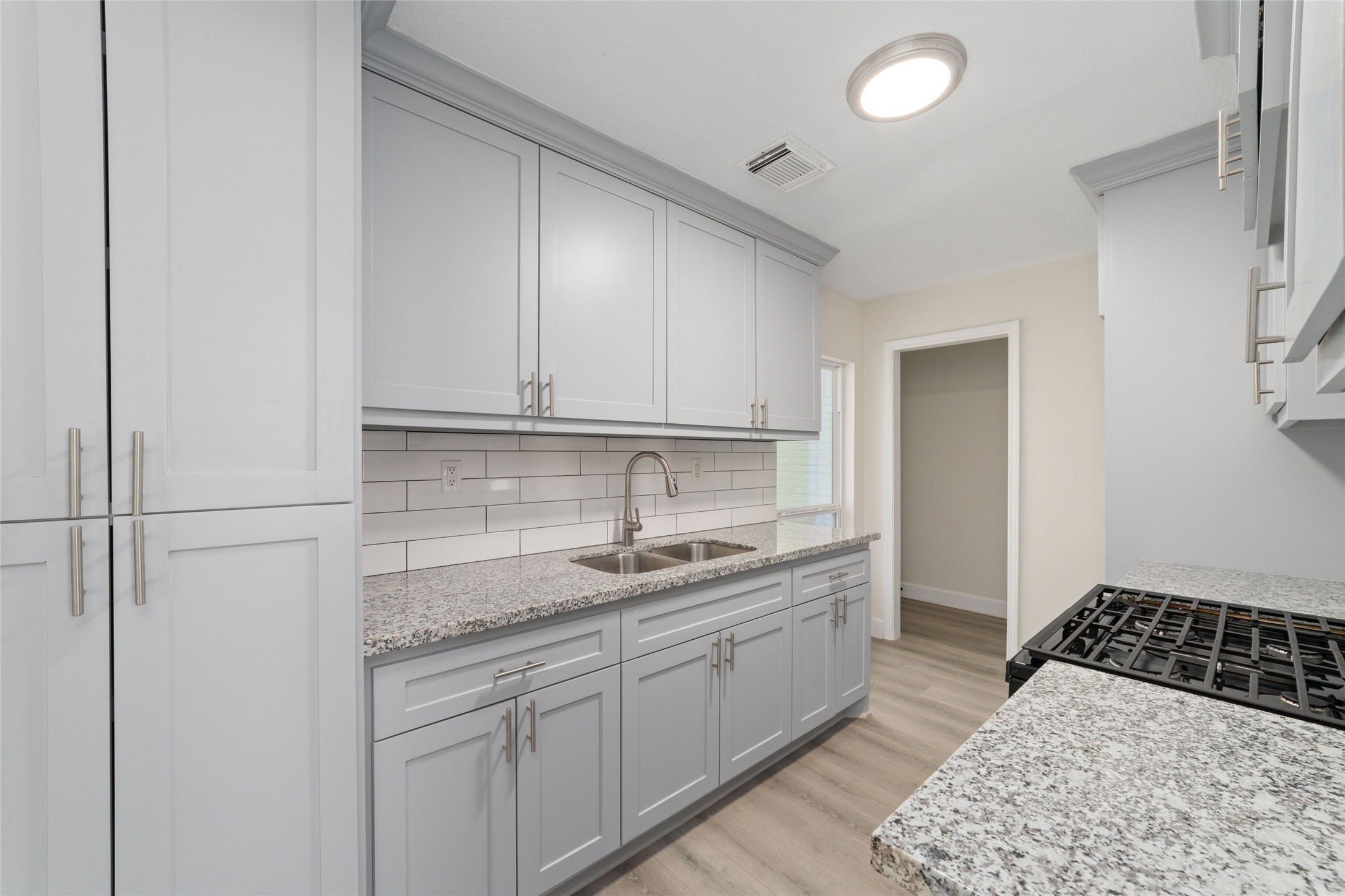 714 East 43rd Street Houston, TX 77022 - Photo 7 of 20 a kitchen with a sink and cabinets