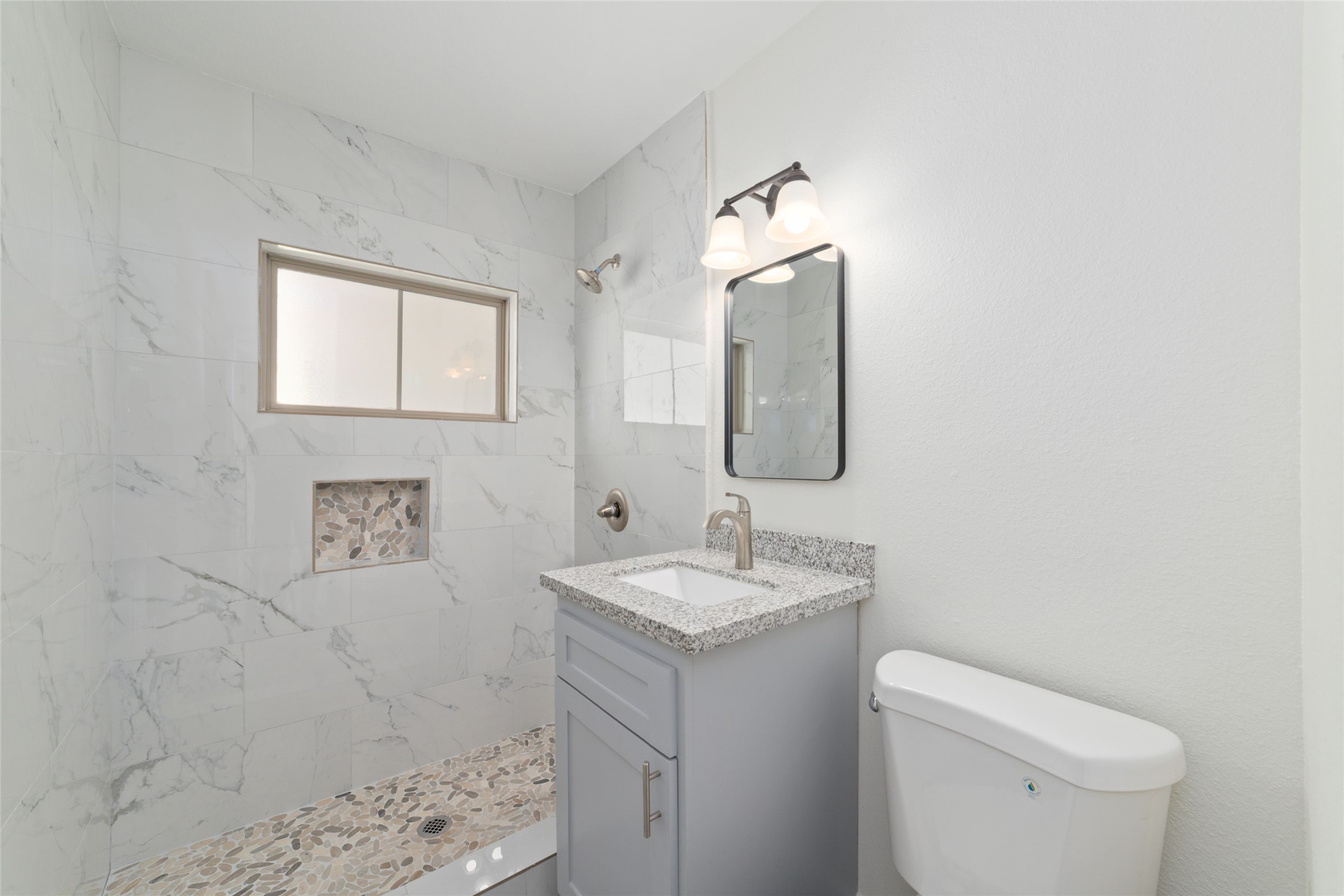 714 East 43rd Street Houston, TX 77022 - Photo 8 of 20 a bathroom with a toilet sink and mirror