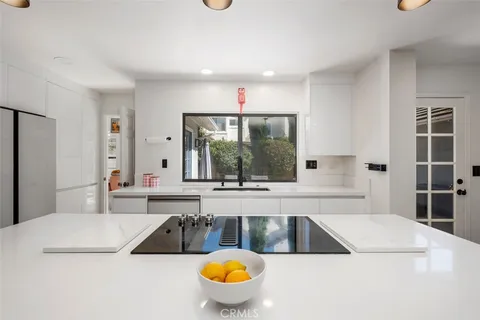 a kitchen with appliances cabinets and furniture