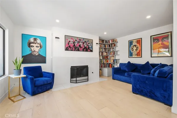 a living room with furniture and large windows