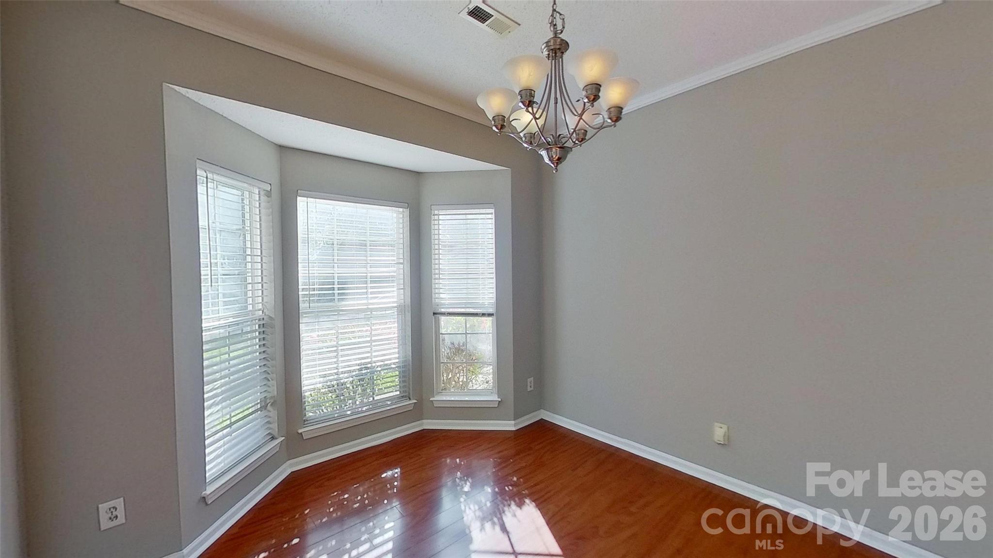 7236 Rock Island Road Charlotte, NC 28278 - Photo 4 of 11 a view of an empty room with wooden floor and a window