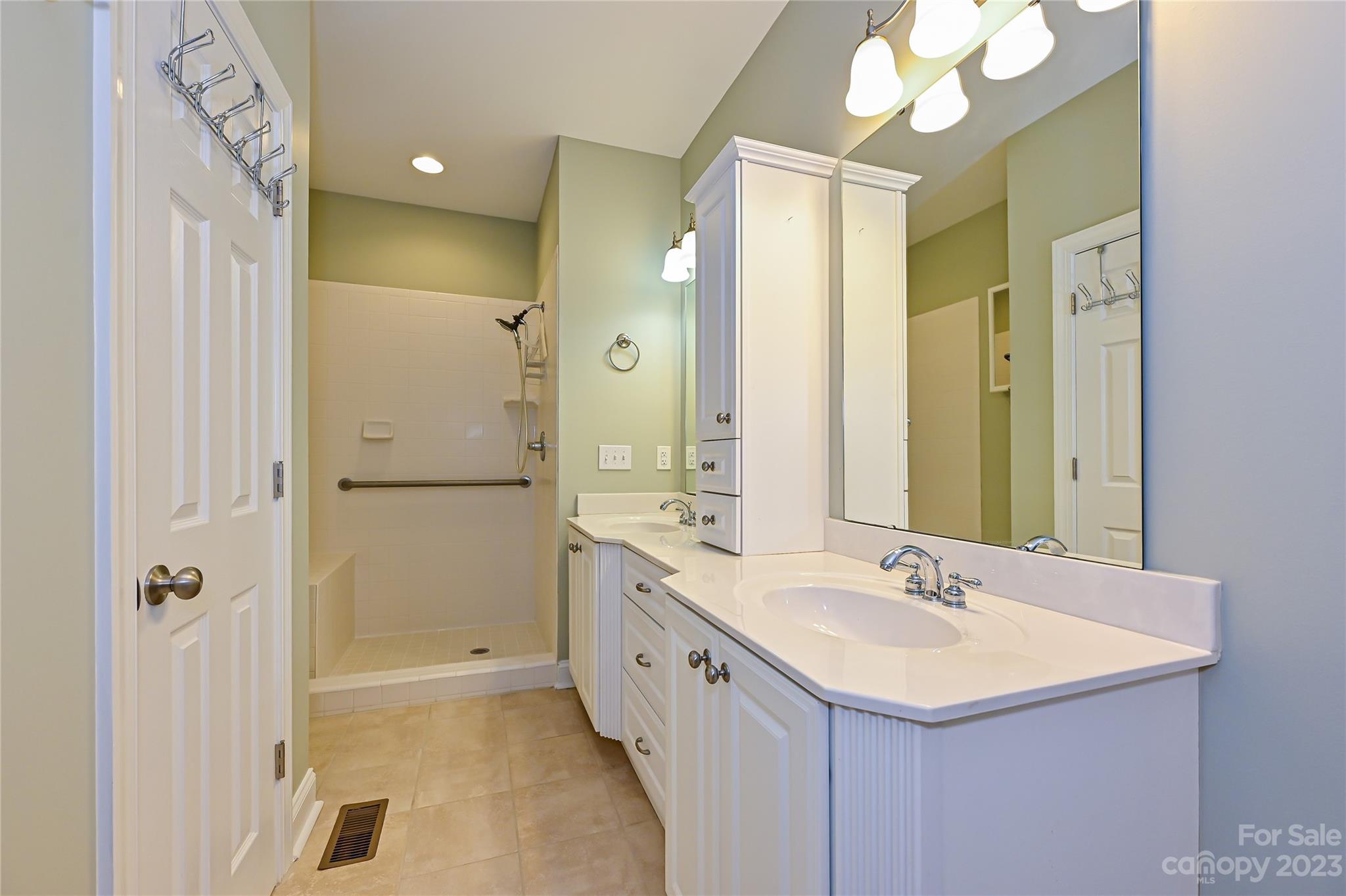 8834 Wingard Road Waxhaw, NC 28173 - Photo 24 of 46 a bathroom with a double vanity sink mirror and shower