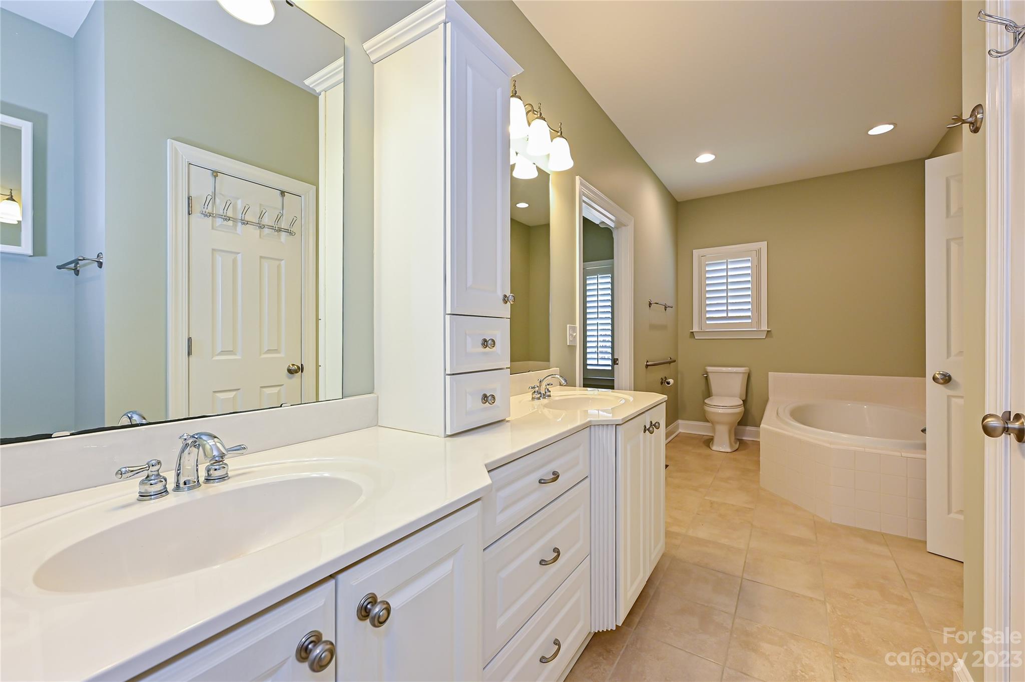 8834 Wingard Road Waxhaw, NC 28173 - Photo 25 of 46 a bathroom with a granite countertop double vanity sink a mirror and a bathtub