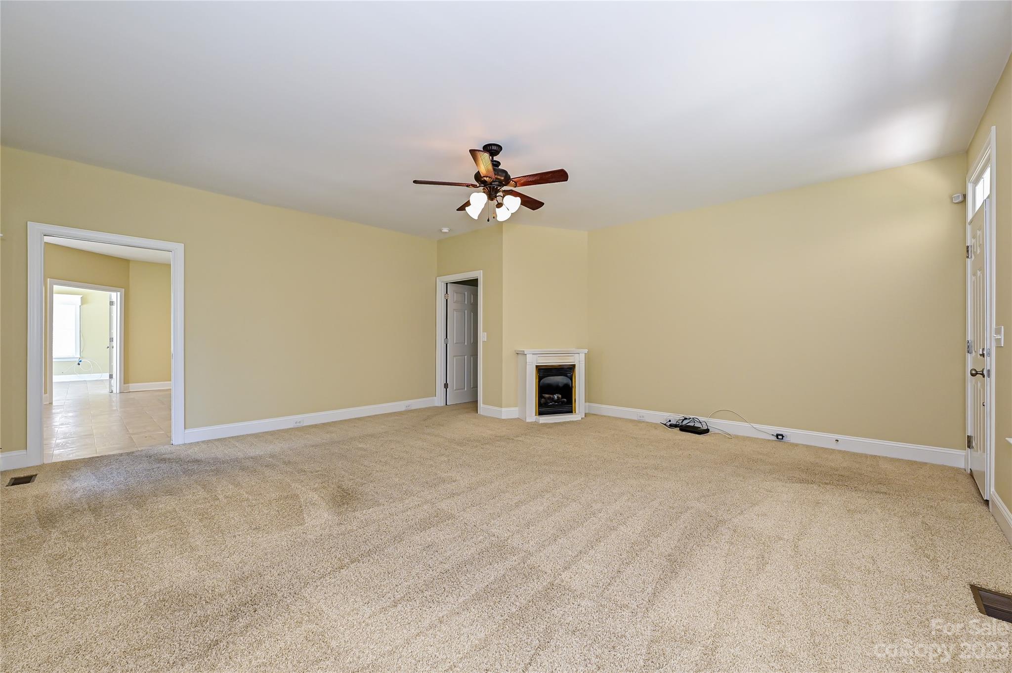 8834 Wingard Road Waxhaw, NC 28173 - Photo 5 of 46 a view of an empty room with a ceiling fan