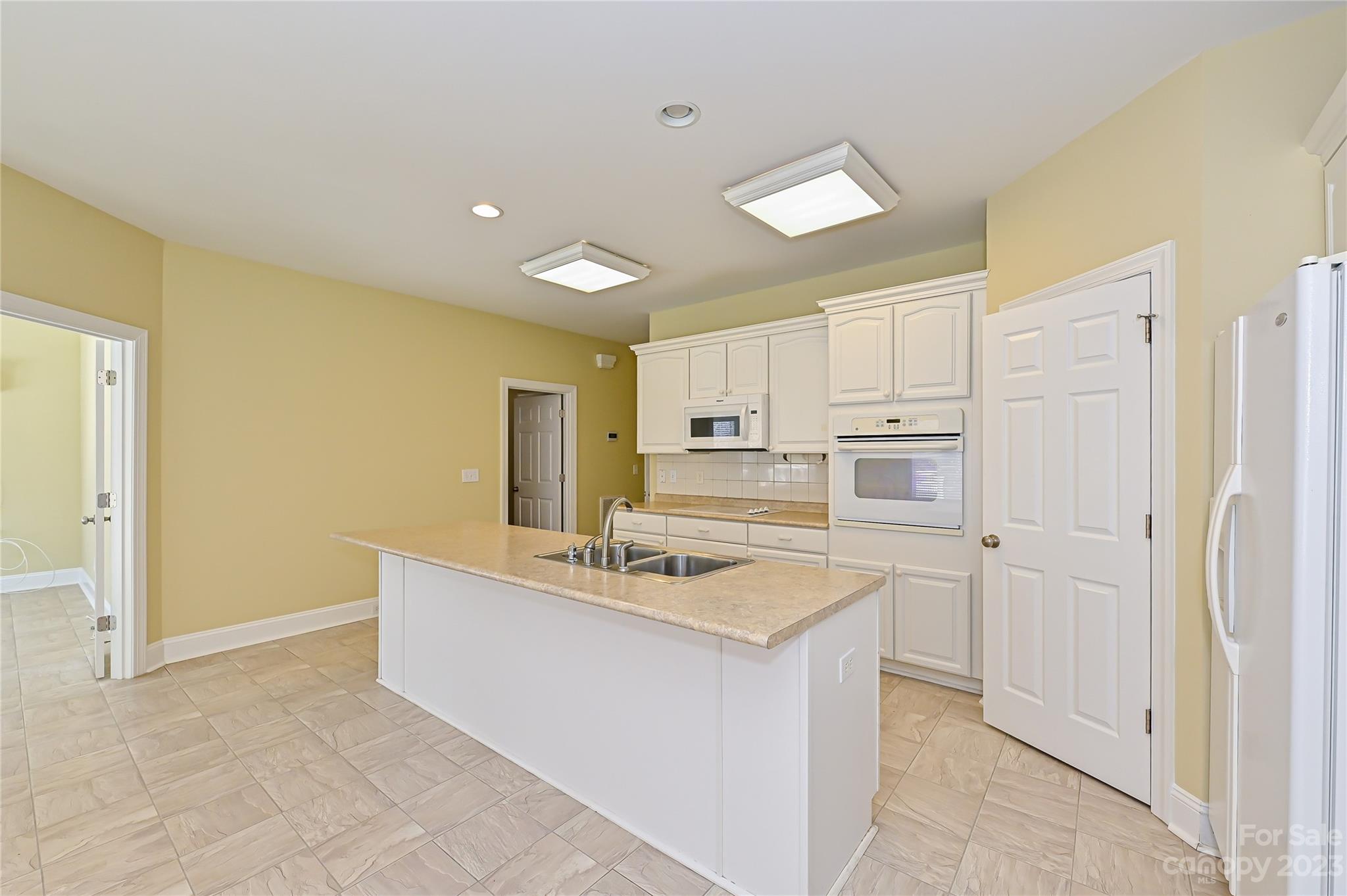 8834 Wingard Road Waxhaw, NC 28173 - Photo 7 of 46 a kitchen with stainless steel appliances granite countertop a sink and a refrigerator