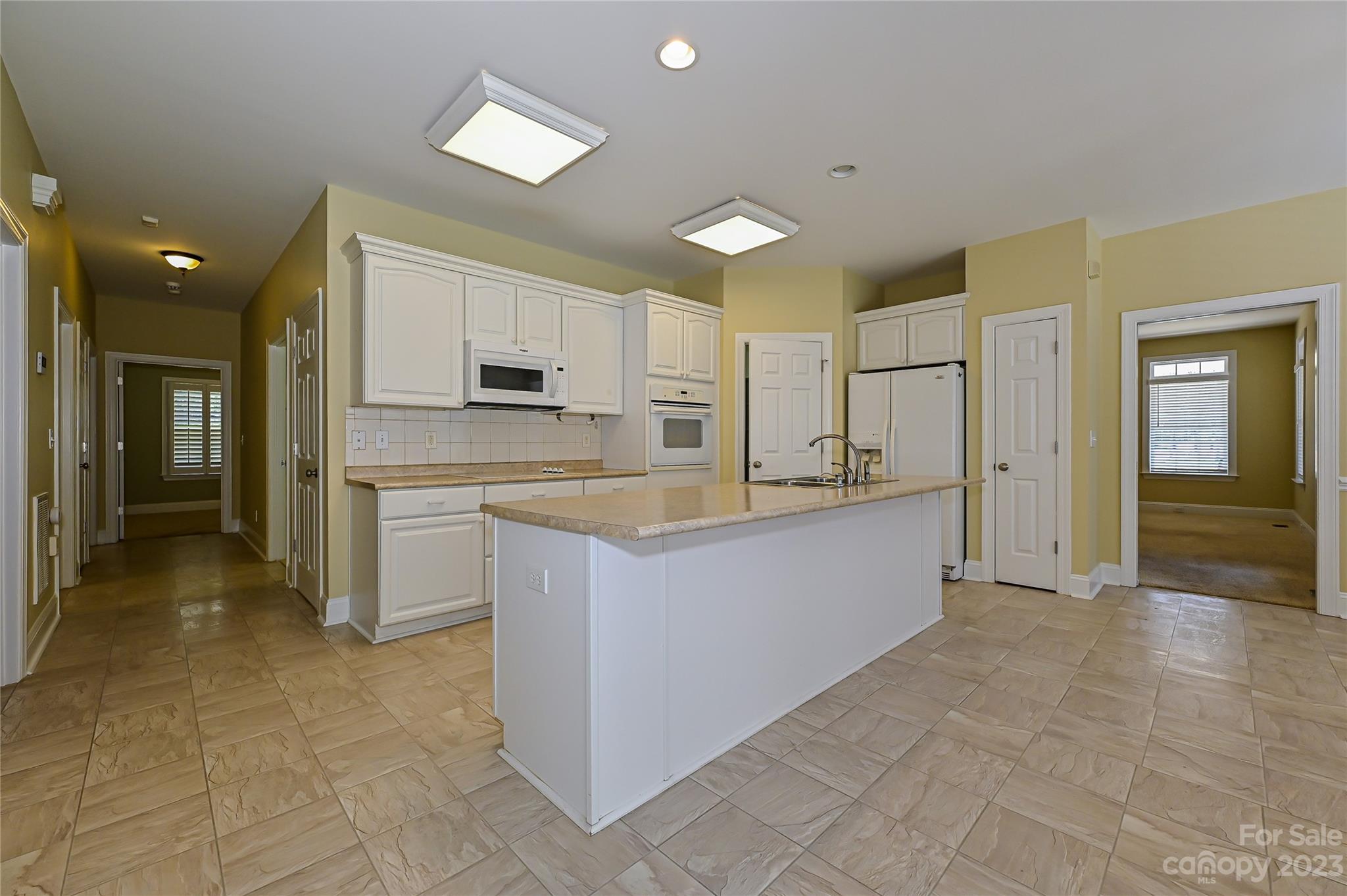 8834 Wingard Road Waxhaw, NC 28173 - Photo 9 of 46 a large kitchen with cabinets and stainless steel appliances